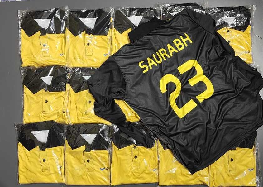 stack of custom sports jerseys with one personalized on top showing player name and number