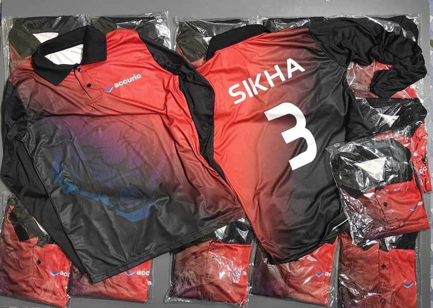 stack of custom sports jerseys with one personalized on top showing front and back, with the back showing the player's name and number.